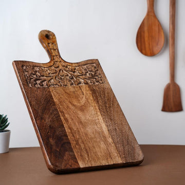 https://www.theindusvalley.in/cdn/shop/products/mango-wood-carved-chopping-board-with-handle-the-indus-valley-1_360x.jpg?v=1640361725